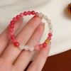 Fresco y de moda ligero diseño de lujo sentido doble concha cuatro hojas pulsera de flores para el viaje diario universal de alta calidad accesorios de mano details Picture